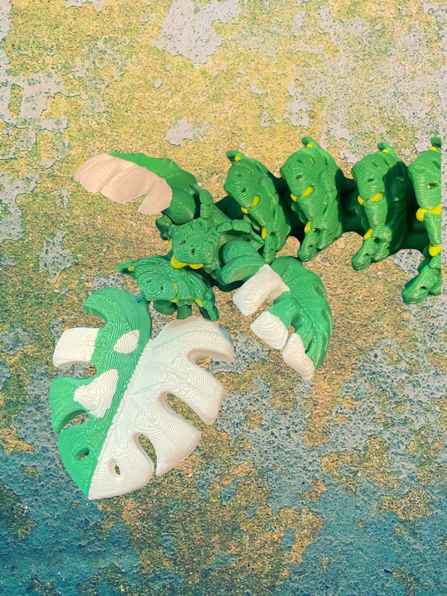 1 Layer At A time Baby Monstera Plant Dragon, a green and white articulated flexi dragon with leafy details, perfect for collectors.