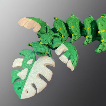 1 Layer At A time Baby Monstera Plant Dragon, a green and white articulated flexi dragon with leafy details, perfect for collectors.