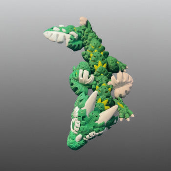 1 Layer At A time Baby Monstera Plant Dragon, a green and white articulated 3D printed dragon with monstera leaf details.
