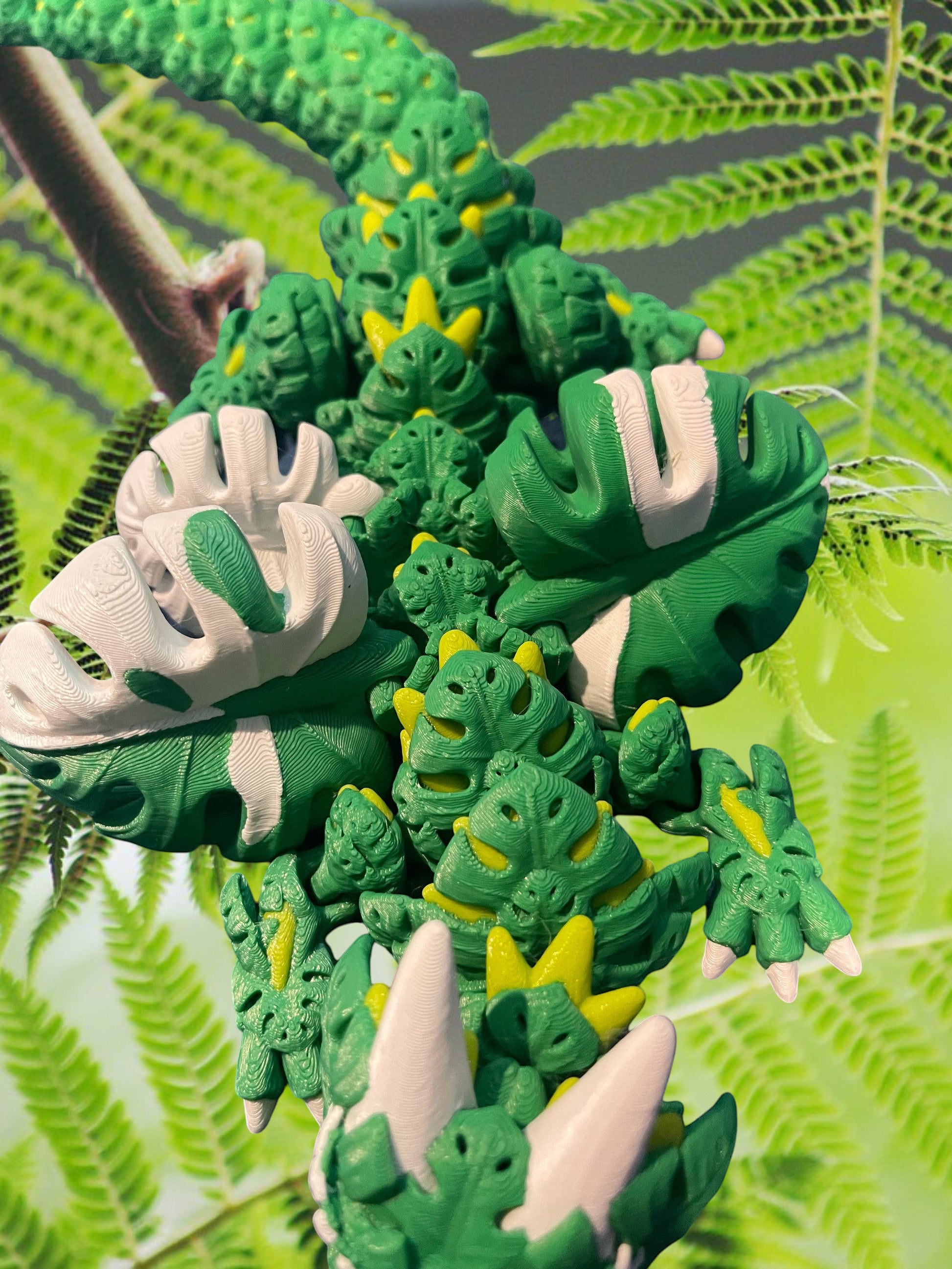 1 Layer At A time Monstera Dragon, articulated fantasy creature with green, yellow, and white leaf-shaped details, 19 inches long.