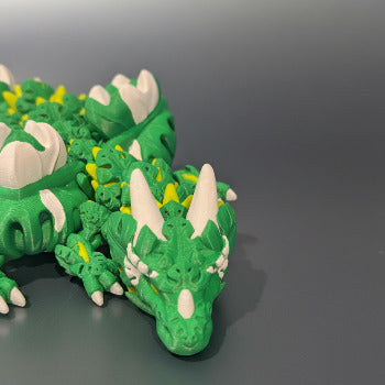 1 Layer At A time Monstera Dragon, a 19-inch articulated fantasy dragon with green, yellow, and white leaf-shaped details, perfect for display or fidgeting.