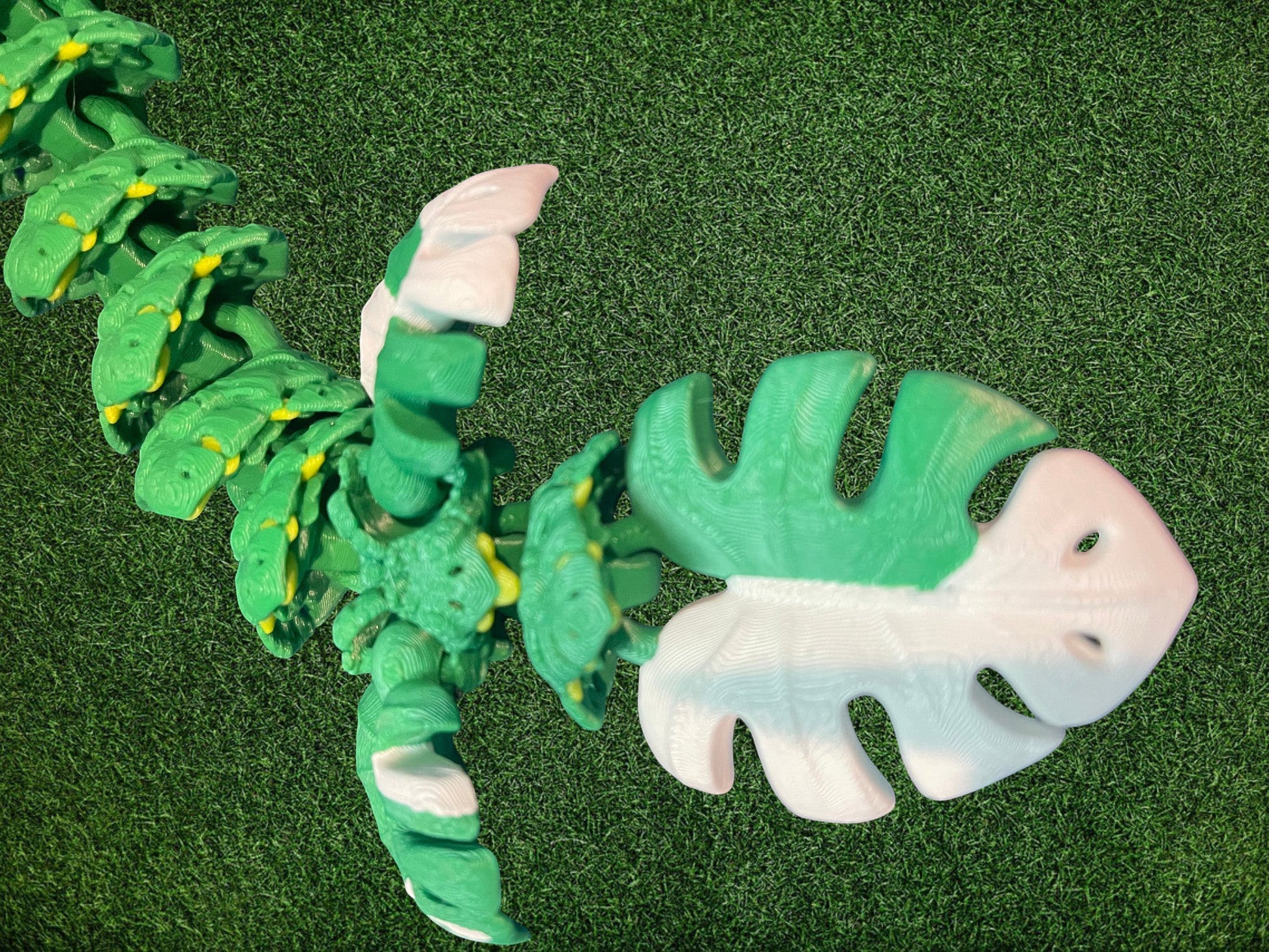 1 Layer At A time Monstera Dragon articulated toy, green and white PLA, leaf-shaped body, 19 inches long.