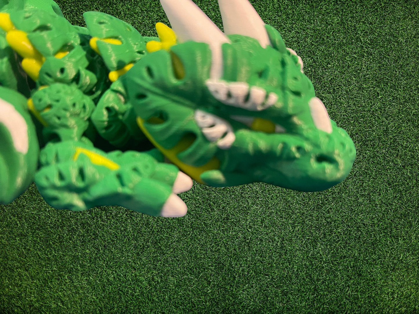 1 Layer At A time Monstera Dragon articulated toy in green, yellow, and white PLA plastic. Features leaf details and smooth movement.