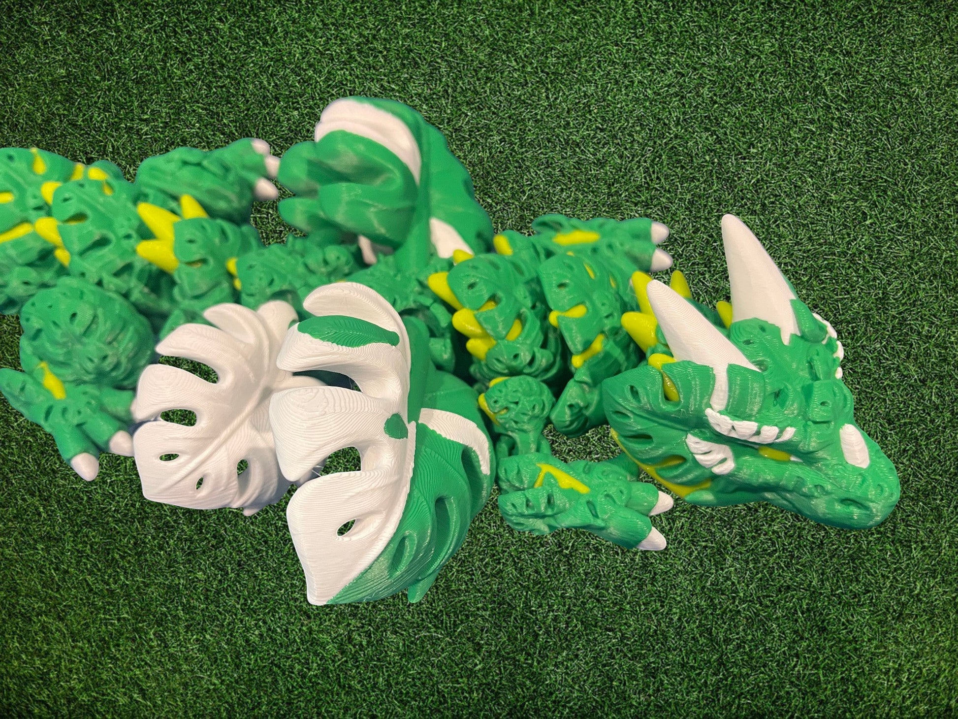 1 Layer At A time Monstera Dragon, articulated fantasy dragon with green, white, and yellow gradient PLA filament, 19 inches long.