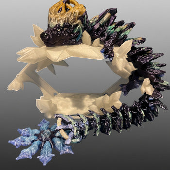 Decorative wreath with a central piece and smaller figurines on a light blue background
